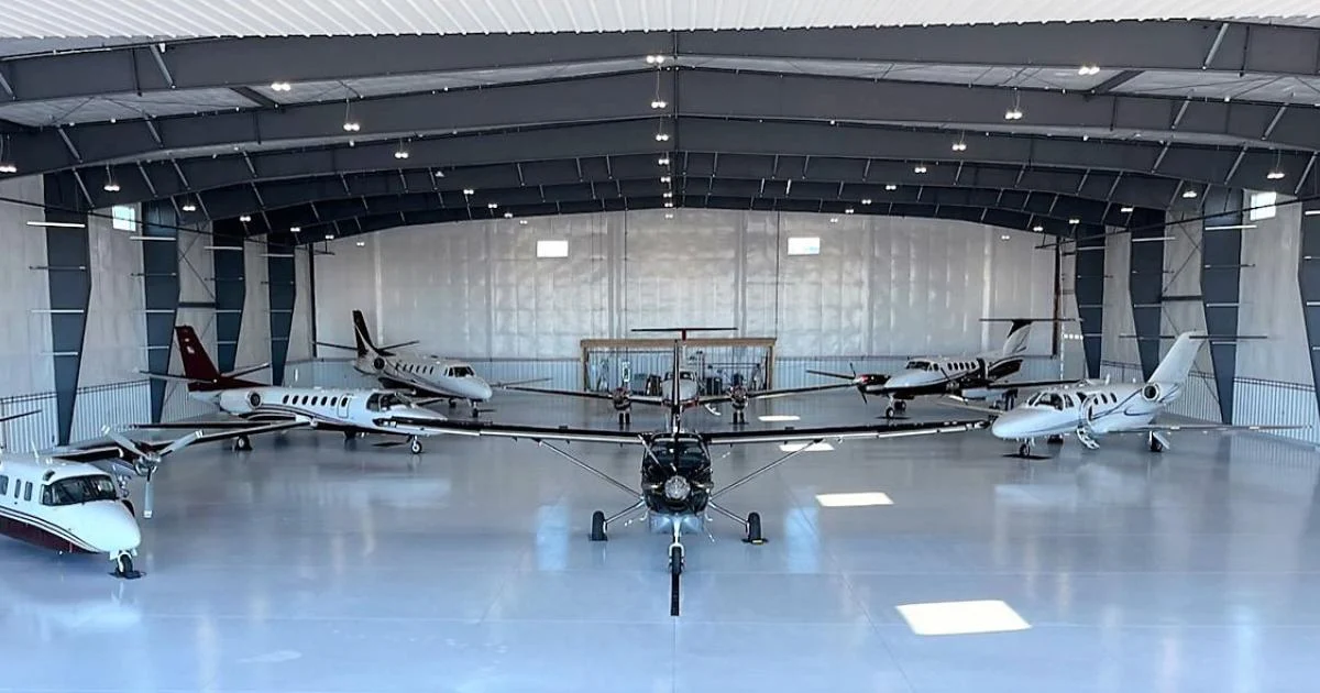 Line service professional assisting a business aircraft at an FBO